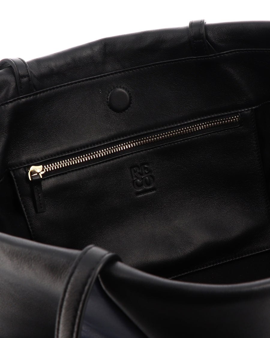 RECO handbag TRIXI crafted from black and dark blue paneled leather showing inside large capacity with a patch interior pocket with zipper 