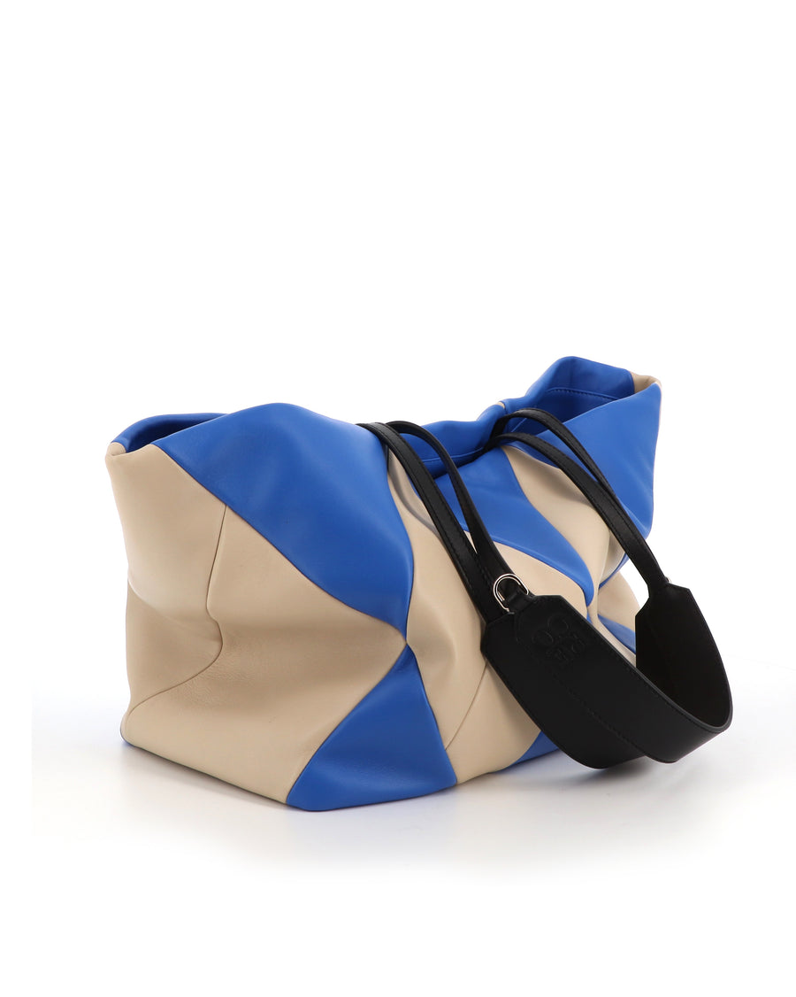 RECO TRIXI handbag in electric blue and white patchwork leather, functional and colorful for everyday use.