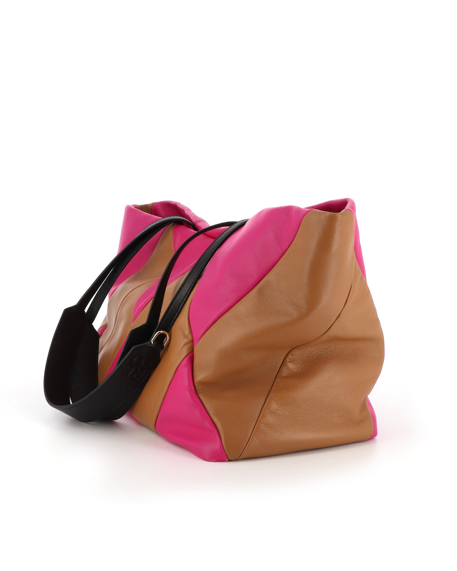 RECO Paris TRIXI bag in fuchsia and brown worn by a woman as an original designer purse with large capacity.