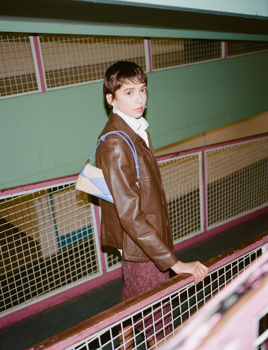 RECO handbag PITI crafted from yellow and lilac paneled leather leather worn by a woman under arm 