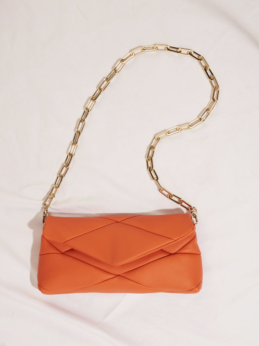 Orange leather handbag with golden chain