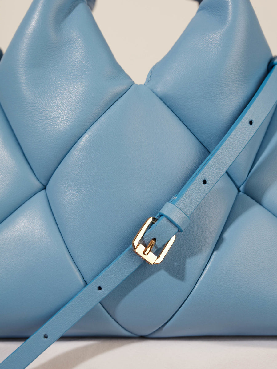 Light blue leather handbag with golden buckle